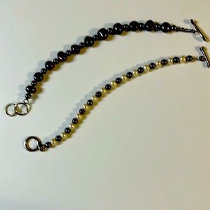 Premier Designs bracelets.  One is “Pearl Soirée” The other is dark gray beads.